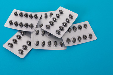  Pills set on the blue paper background 