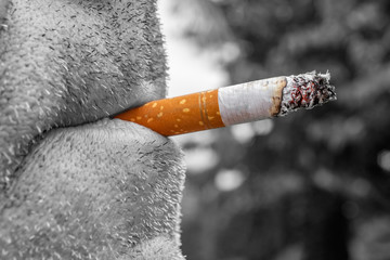   Old man smoking cigarette outside, close up.