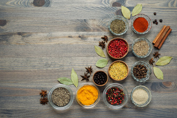 Spices and seasonings on the gray wooden background. Place for text.