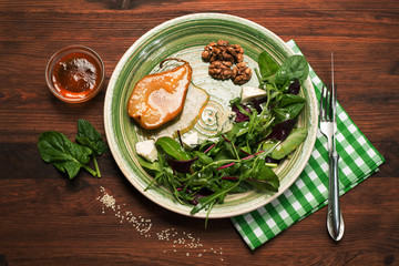 Pear, stewed in honey, mix salad with young spinach, arugula, beet leaves, blue cheese, walnuts on...