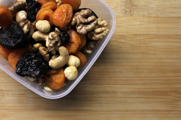 Dried fruits and nuts in plastic container
