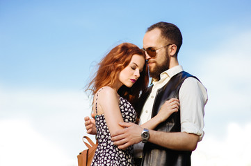 Hipsters. Fun and a lovely family portrait of a young cheerful joyful couple. Smile and feels happy. Outdoor shot of young beard male with his ginger girlfriend. Love story. Valentine Day