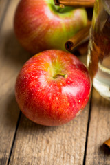 Apples with cinnamon on rustic wooden background. Selective focus. 