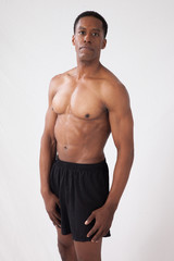 Fototapeta na wymiar Strong Black man flexing muscles