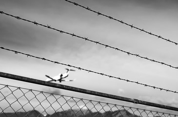 Airplane is blurred behind a fence