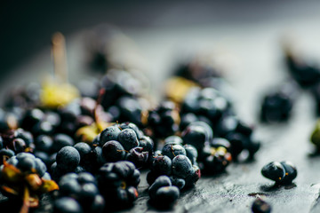 blackberry berries dark blue on black stone background