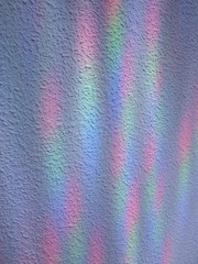 White stipple effect wall with rainbow lights texture background