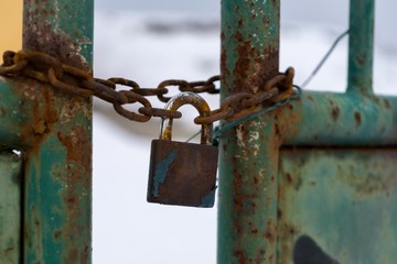 Padlock on the gate in the meadow fence. Slovakia