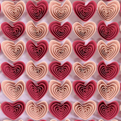 Arrangement of red and pink hearts on a light background. 3D illustration