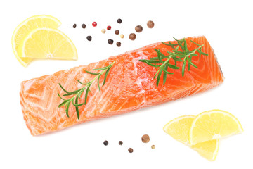 Red fish. Raw salmon fillet with rosemary and lemon isolate on white background. Top view.