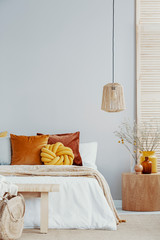 Natural style bedroom with decorations in yellow and orange color