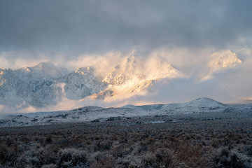 snow clouds in morning light deposited fresh snow on desert valley and Sierra Nevada mountain range
