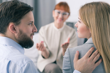 Bearded husband and blond wife reconcile after successful Psychotherapy session for marriage