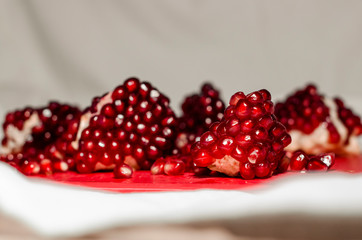 Opened and cutted pomegranate on the red board