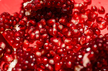 Opened and cutted pomegranate on the red board