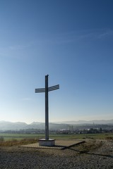 Fototapeta na wymiar Iron cross statue on the meadow above the city. Zilina, Slovakia