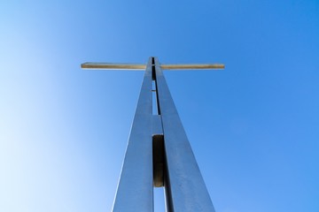 Iron cross statue on the meadow above the city. Zilina, Slovakia