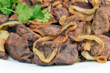 Portion of fried carne de sol in white plate