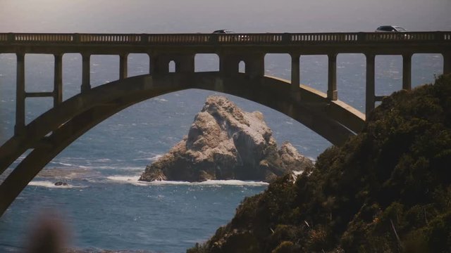 Atmospheric close-up shot of iconic Bixby Canyon Bridge, Highway One and Pacific Ocean coast in Big Sur California USA.