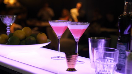 Presentation of non-alcoholic cocktails, analogue of cosmopolitan cocktail, moktel, glasses at the bar, cocktail party, competition of non-alcoholic cocktails, bar, restaurant.