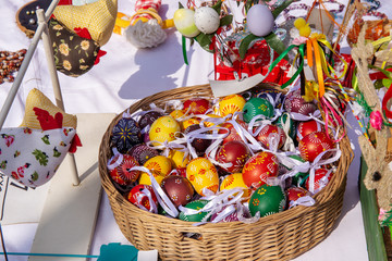 Decorative Easter eggs in basket and other toys for sale on market stall