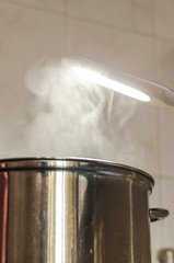 Steam is going out of the kitchen pot