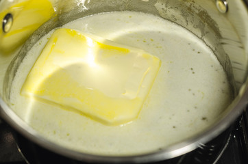 Melting butter in the pan on the stove 