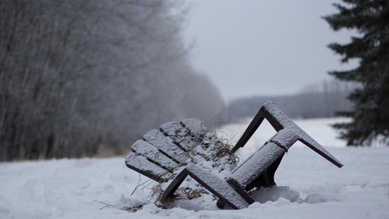 Old Adirondack chair in a wintery field