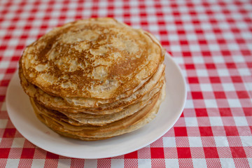 Thin pancakes with crispy crust. Maslenitsa. Pancakes for breakfast and carnival.