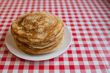 Thin pancakes with crispy crust. Maslenitsa. Pancakes for breakfast and carnival.