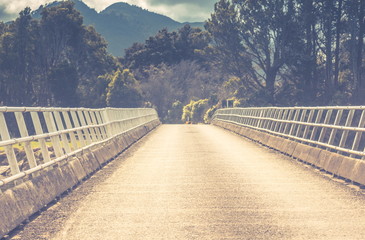 landscape image of a one way bridge in New Zealand.