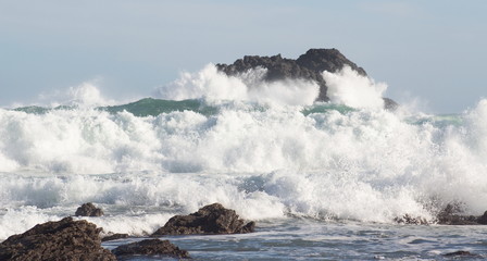 Landscape image of Ocean Waves Crashing against Coastal Rocks at Cape Palliser, Wellington, New Zealand.