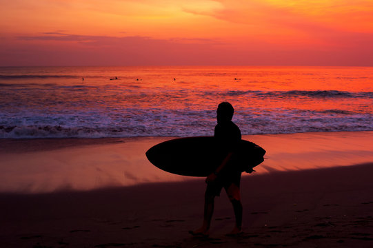Surfer surfing ocean silhouette beach