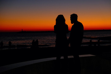 Fototapeta na wymiar couple on the beach at sunset