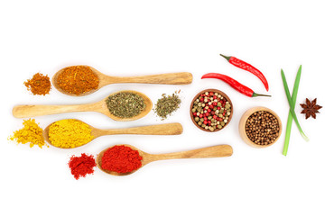 mix of spices in wooden spoon isolated on a white background with copy space for your text. Top view. Flat lay. Set or collection