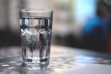 Glass of cold mineral water on the table.