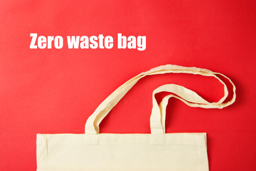 White tote canvas fabric, eco bag cloth shopping sack on colrful red background . Zero waste...