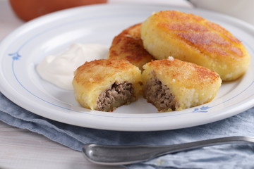 Potato meat filling patties with sour cream