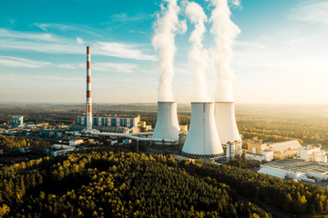 A Power plant with white smoke over it's chimneys - obrazy, fototapety, plakaty