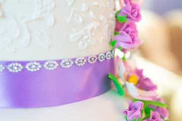wedding cake decoration. beautiful wedding cake with purple orchids. cake in violet tones