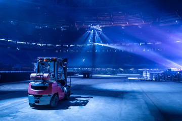 Forklift. Stacker in the spotlight. Production. Loader. Industrial machines. Forklift stands on a...