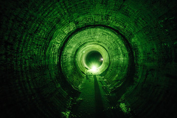 Flooded round underground drainage sewer tunnel with dirty sewage water green illuminated - obrazy, fototapety, plakaty