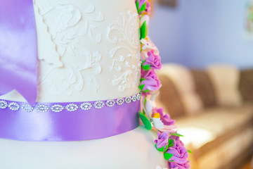 wedding cake decoration. beautiful wedding cake with purple orchids. cake in violet tones