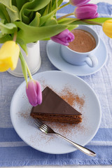 Chocolate cake, coffee and tulips