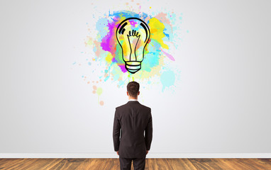 Businessman looking to a wall with new idea concept
