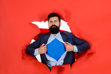 Through paper. Bearded man looking through paper. Super businessmen in red cape showing blue shirt....