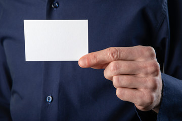 A man holding white business card