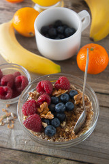 Cereal, muesli and various delicious fruit, berries for breakfast. healthy, energy breakfast, wooden table.