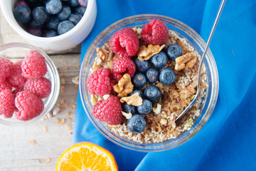 Cereal, muesli, granola and various delicious fruit, berries for breakfast. healthy, energy breakfast, wooden table.