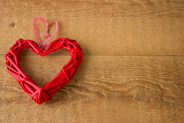 The Valentine Day Concept. Red heart on a wooden background.